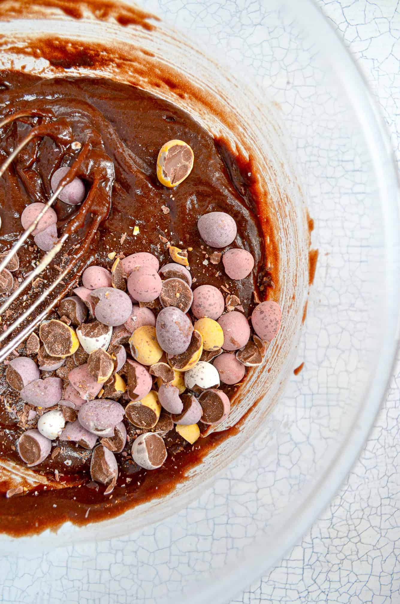brownie batter with mini eggs in bowl