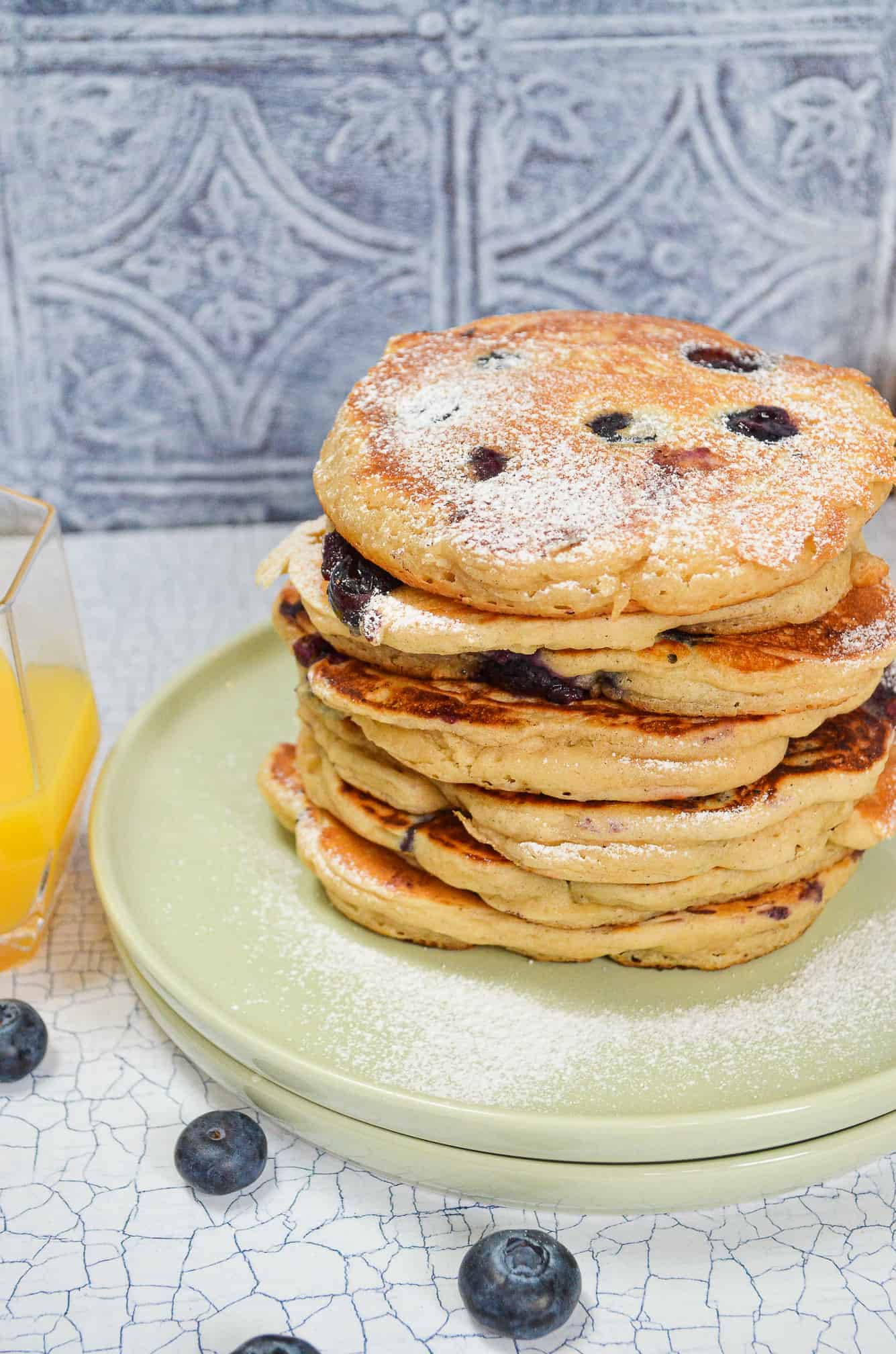 stack of vegan blueberry pancakes with icing sugar