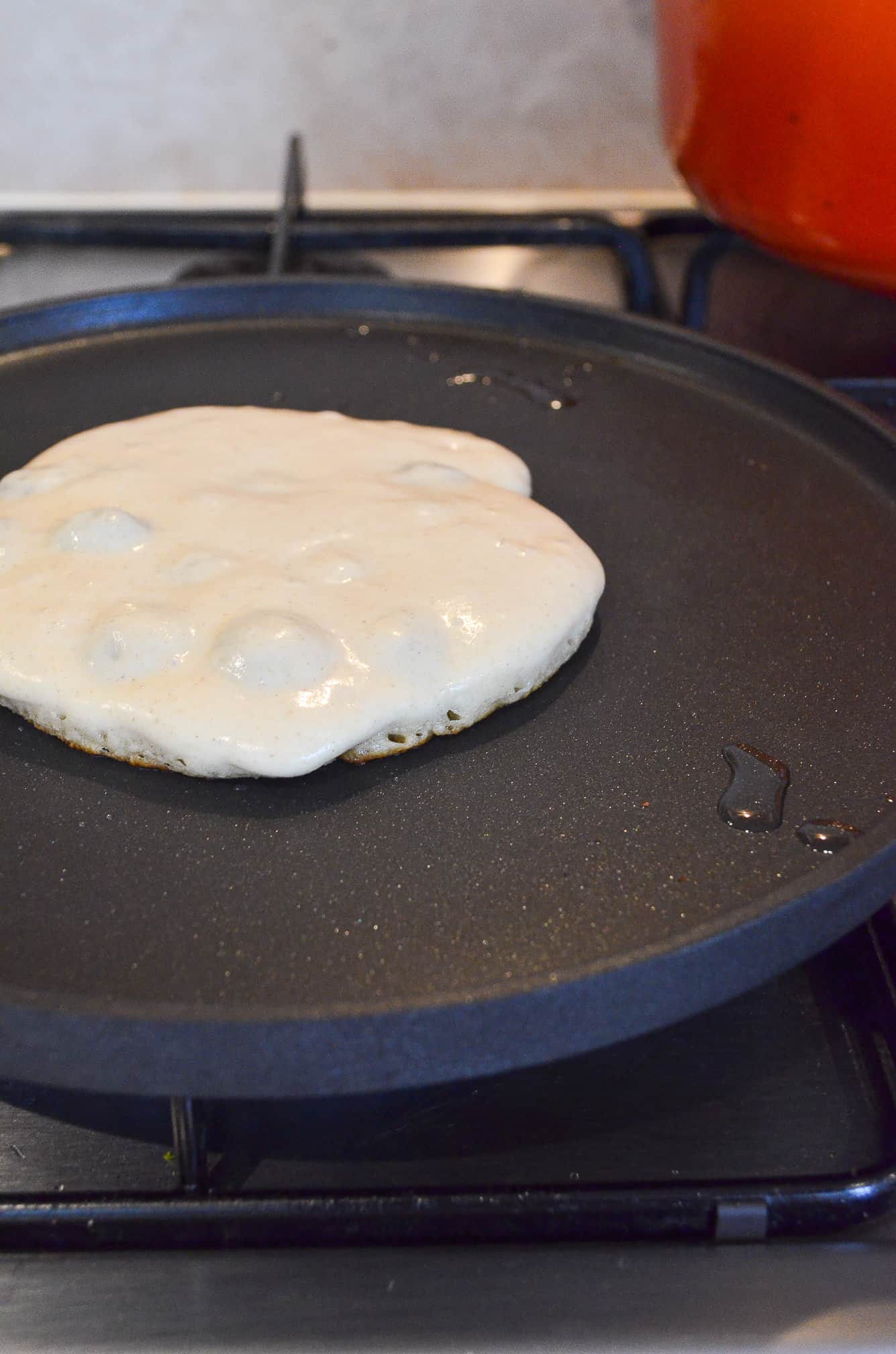 vegan blueberry pancake on frying pan