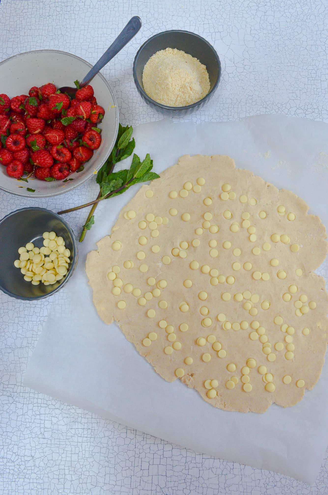rolled out pastry with white chocolate chips in for galette