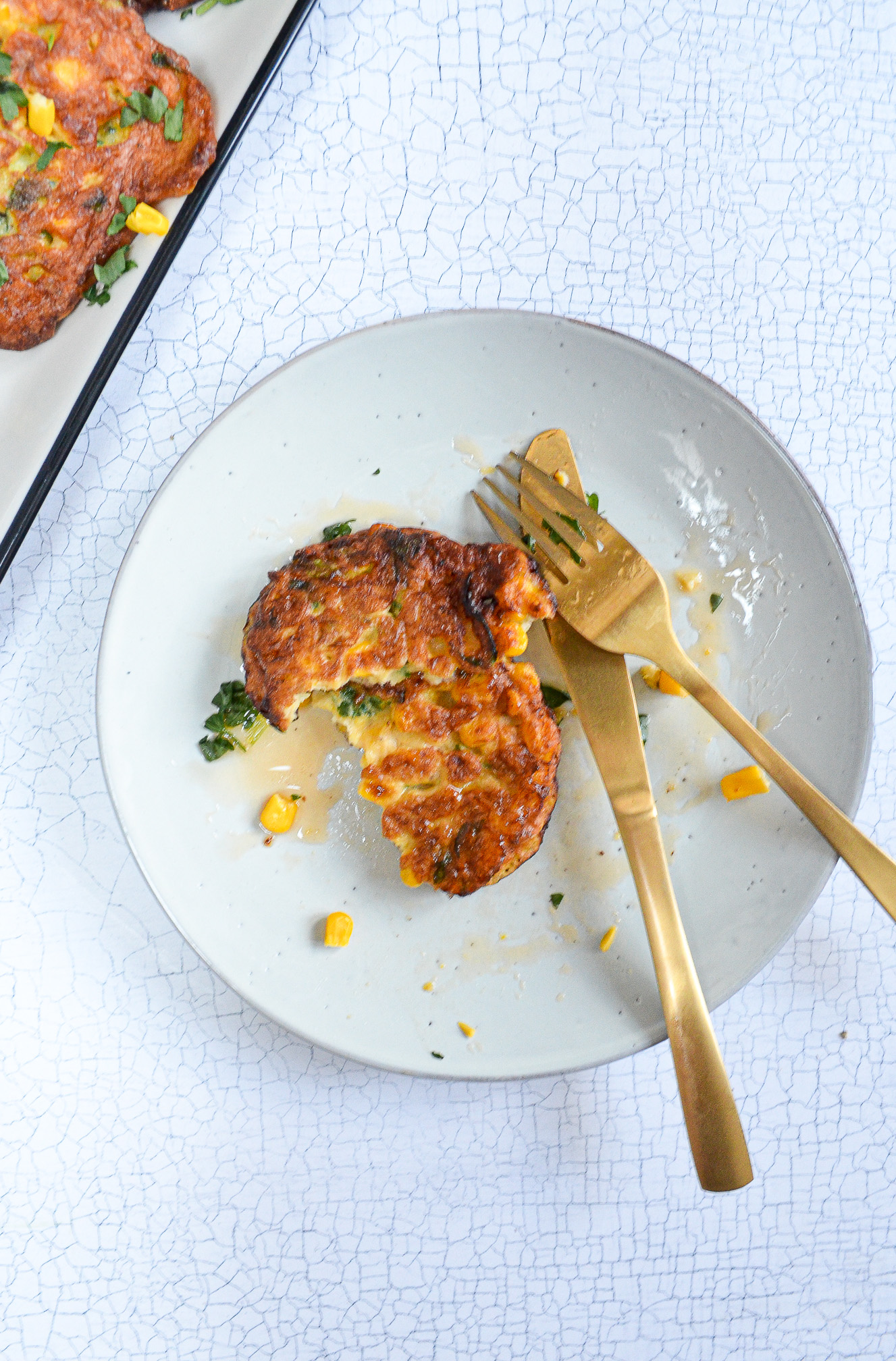 sweetcorn fritters on a plate drizzled with chilli hot honey